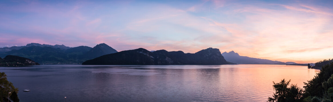 Large magnificent  panorama  extra wide.  XL Switzerland. Large panorama of Lake Lucerne. Mountains in the evening sunset. In the background city of Lucerne.