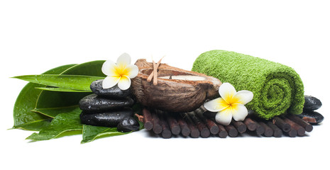 Spa objects with tropical flower and candle on white background.