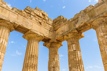 Fototapeta premium Ruins of the doric Temple of Hera (Temple E) inside the archaeological park of Selinunte, an ancient Greek city on a seaside hill in the south west coast of Sicily.