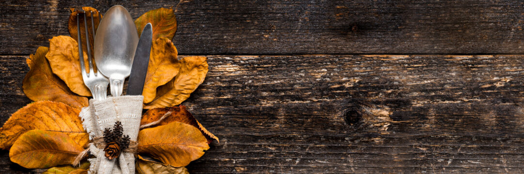 Thanksgiving Meal Setting Banner. Seasonal Table Setting. Thanksgiving Autumn Place Setting With Cutlery And Arrangement Of Colorful Fall Leaves.