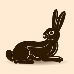 Dark brown hare with long ears looks at the back, silhouette on a pink background,