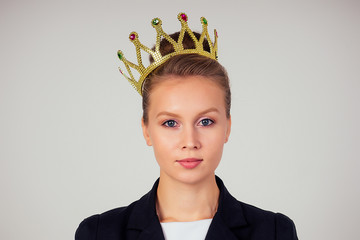 Young business woman put on the crown on head. Leadership, success concept