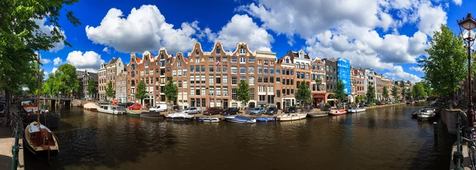 Foto op Aluminium Beautiful panoramic linear panorama of the UNESCO world heritage Prinsengracht canal in Amsterdam, the Netherlands, on a sunny summer day with a blue sky and clouds   © dennisvdwater