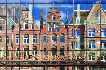 Schilderijen op glas Facade with reflection of the DeLaMar theater in Amsterdam, The Netherlands   © dennisvdwater