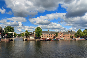 Beautiful view of museum the Hermitage at the river Amstel in Amsterdam, the Netherlands, on a sunny summer day with clouds, on June 30, 2014
