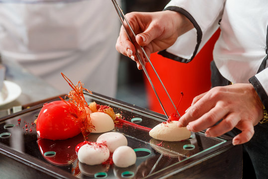 Putting cherry at yogurt sphere