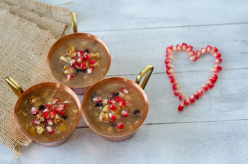 Turkish traditional dessert Ashura, Noah's pudding on wooden  background.Top view.