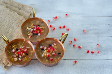 Turkish traditional dessert Ashura, Noah's pudding on wooden  background.Top view.
