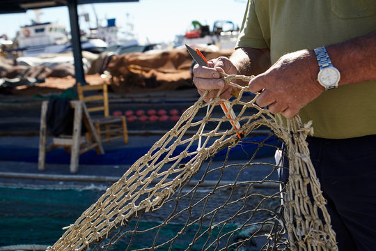 Man holding fishing net in hands