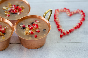 Turkish traditional dessert Ashura, Noah's pudding on wooden  background.Top view.