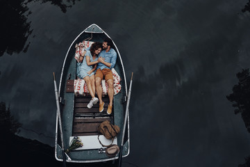 Loving couple in boat. 