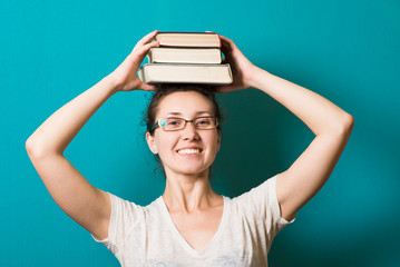 beautiful brunette girl in glasses with books