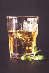 Glass of rum on the dark background