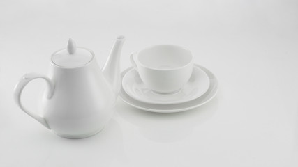white ceramic teapot with cup on light background