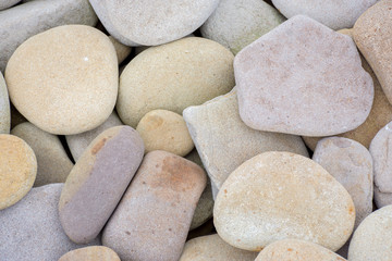 Several round beautiful smooth stones on the seashore