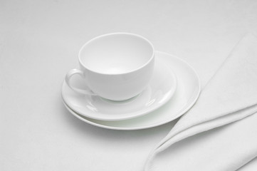 ceramic white cup with napkin on white background