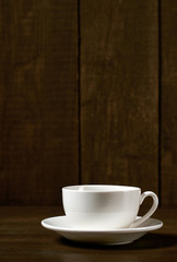 one classic coffee or tea cup on a dark wooden background