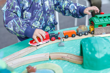 Autistic kid play alone with train toys