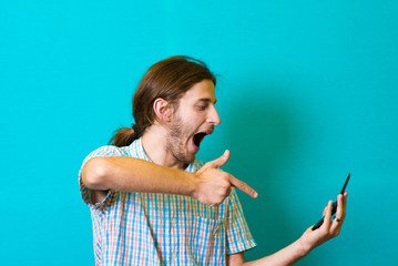 Handsome hipster showing his phone