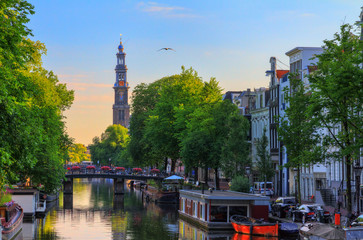 UNESCO world heritage Prinsengracht canal with the Westerkerk (Western church) on a summer morning...