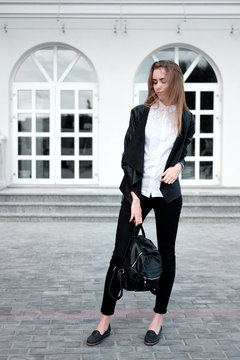 Young Attractive Stylish Woman In White Shirt And Black Trousers