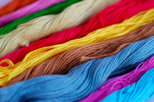 Multicolored thread for embroidery. Macro. Colorful thread stacked in a pile. Embroidery is a kind of needlework and a hobby.
