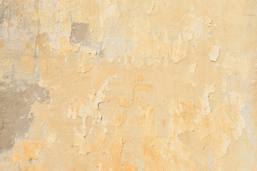 texture of old peeling yellow plaster