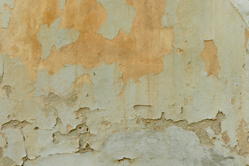 texture of old peeling yellow plaster
