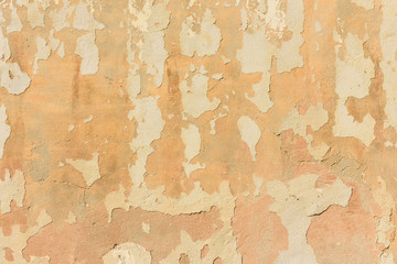 texture of old peeling yellow plaster