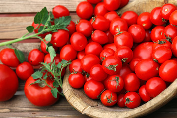 Fresh tomato crop in a wooden bowl