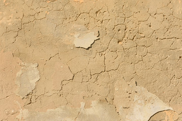 texture of old peeling yellow plaster