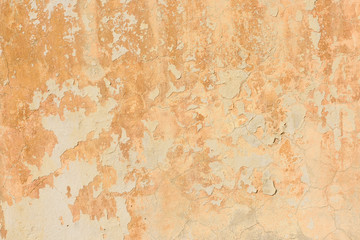 texture of old peeling yellow plaster