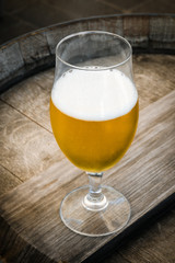 glass of beer on wooden background