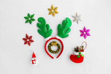 Christmas composition.  Christmas Reindeer headband and ornaments on white background. Crative flat lay , top view