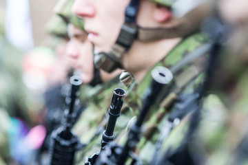 Close up , soldier holding gun