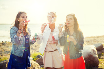 summer vacation, holidays, fun and people concept - group of happy young women or teenage girls...