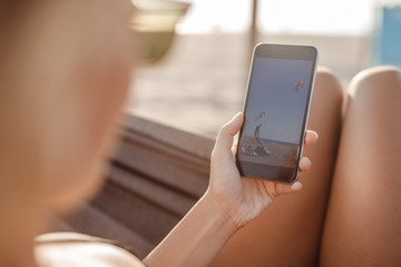 A Woman Using Cell Phone at Beach