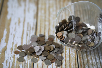 Accumulated coins stacked in glass jars