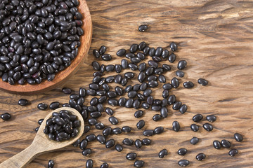 Raw black beans on the wooden background - Phaseolus vulgaris' Black turtle