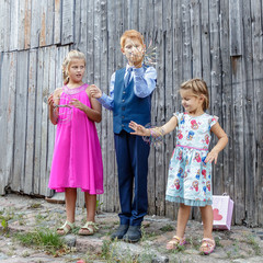 brother and two sisters pose for photographer
