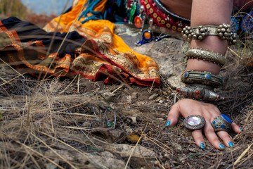 Tribal style jewelry on the hands of close-ups, iron rings and bracelets