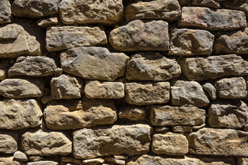 Front view of old exterior wall stone brickwork - concept texture, background, stone design illustration graphic composition wallpaper