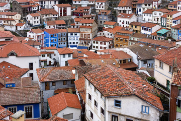 Fototapeta na wymiar Spain, Asturias, Cudillero, Cuideiru: Colorful traditional houses with red roof tops and narrow alleys in the city center of the small Spanish village. Legend says it was founded by the Vikings.