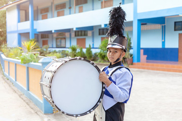 child holding big vintage orchestral drum