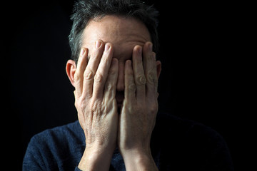 Man's portrait with dramatic light, black background