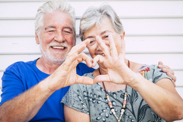 playful beautiful cheerful caucasian adult senior couple enjoying lifestyle toghetner with smile...