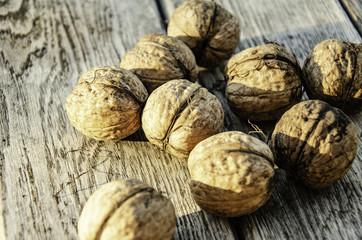 Harvest of a walnut in a garden on a wooden background.