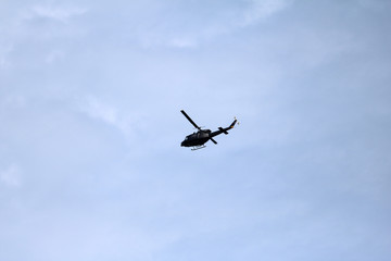 black helicopter aircraft during the flight with blue sky
