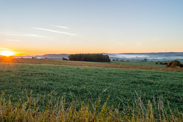 View of the prairies of Gaume at sunrise in southern Belgium