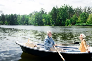 Foto op Canvas Calm rowing. Calm active pensioners enjoying the nature and feeling good while rowing the boat © Viacheslav Yakobchuk